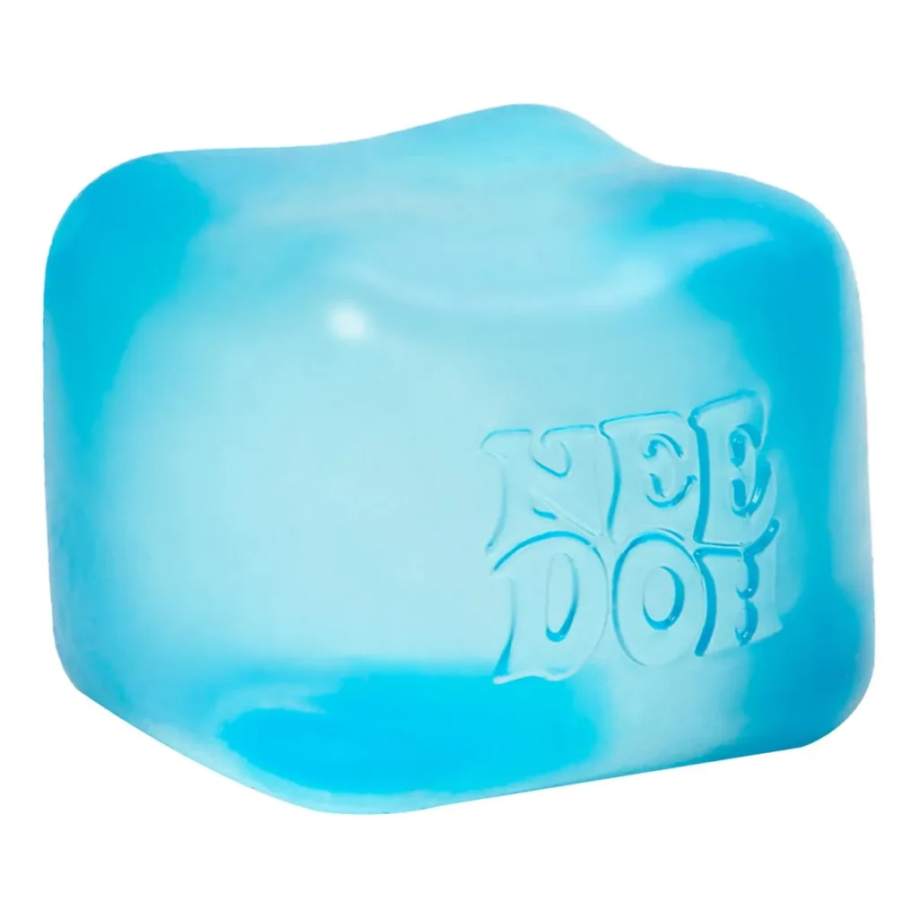 Translucent blue NeeDoh Nice Cube against a simple pale background, showing its clear, solid, square squish body. — Image 1 of 10