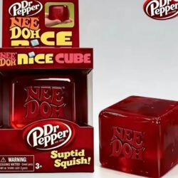 Close-up of a translucent red NeeDoh Dr Pepper Nice Cube with light shining through the squishy toy — Image 1 of 1